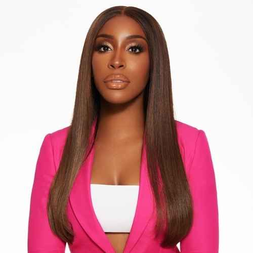 A portrait of a woman with long, straight brown hair, wearing a bright pink blazer and a white top.