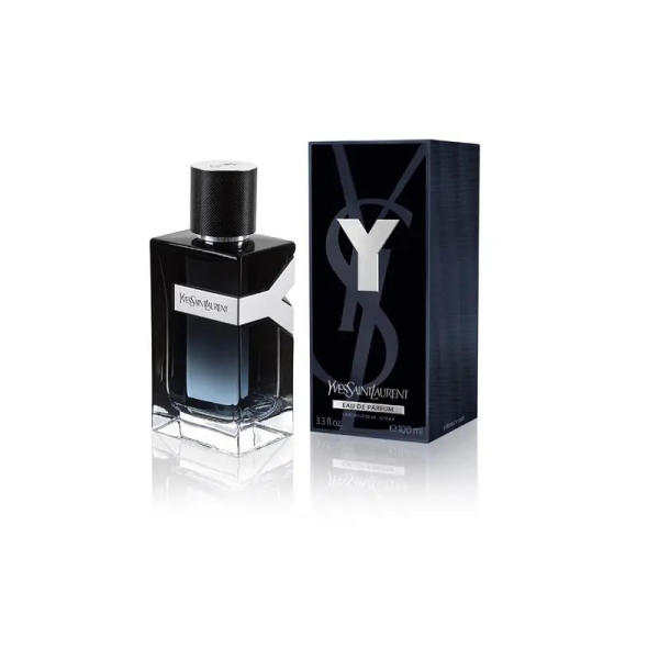 A close-up shot of a bottle of Yves Saint Laurent Y Eau de Parfum. The bottle has a clear base with a blue liquid that graduates to a deep, dark blue at the top. A white label with "Yves Saint Laurent" is wrapped around the middle of the bottle. The bottle is topped with a black cap.