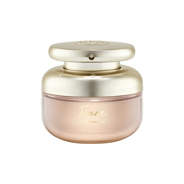A pink and gold bottle of Rare Beauty Rare perfume on a white background.